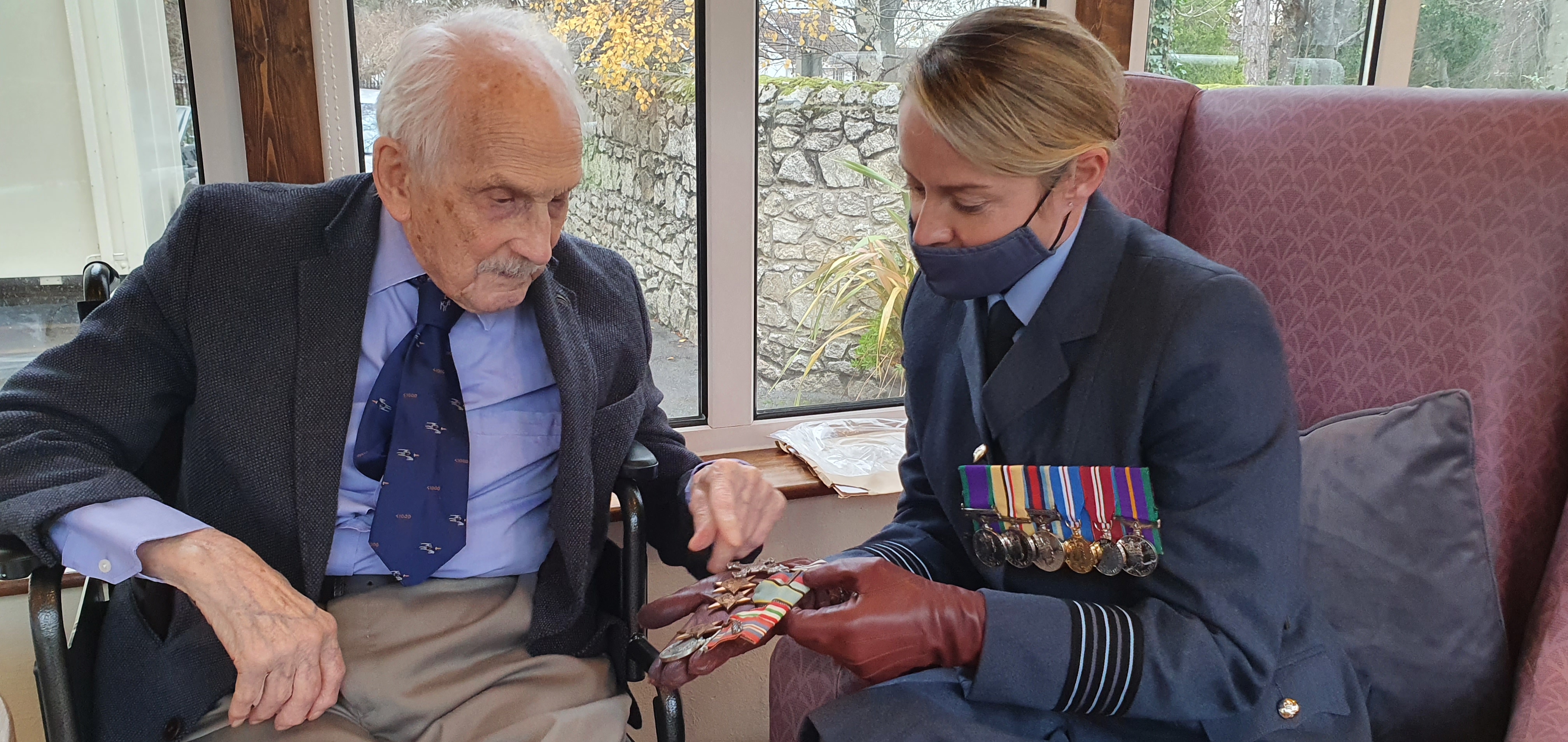 John and Wing Commander Rankin hold the restored medals.